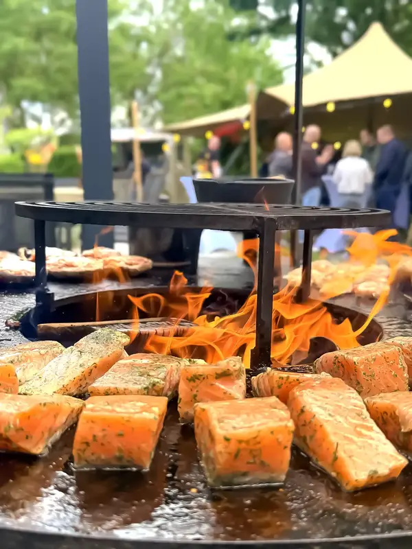 Zalm wordt boven open vuur bereid door Jeff’s Catering